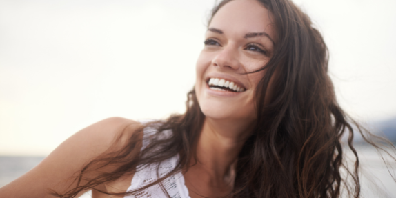 woman smiling after microneedling treatment at kent laser