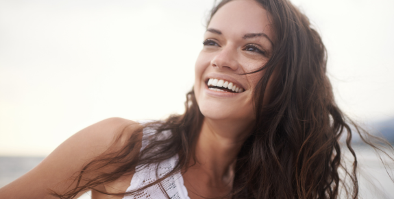 woman smiling after microneedling treatment at kent laser
