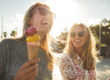 women smiling eating ice cream after having microneedling treatment