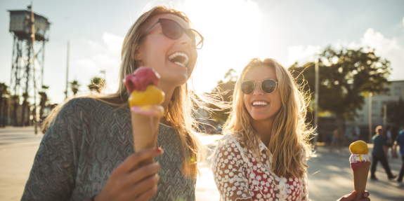 Mironeedling for acne scars – image women smiling eating ice cream after having microneedling treatment
